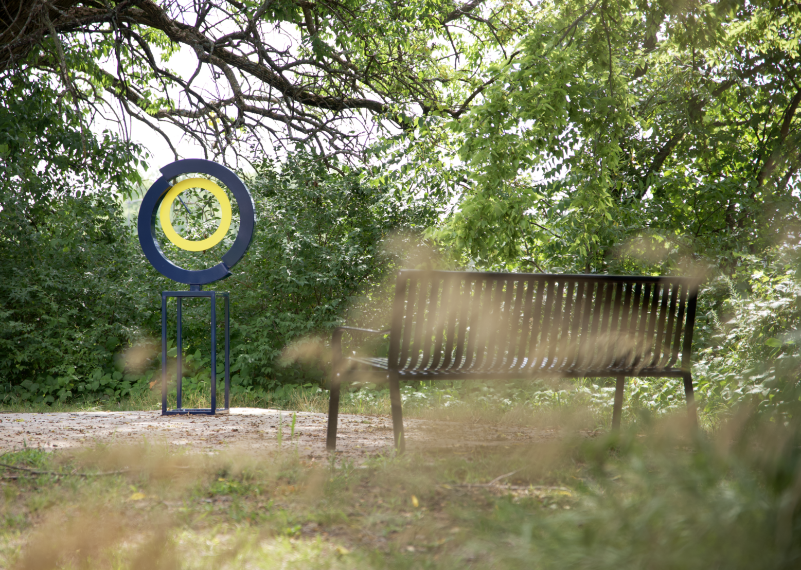 A circular sculpture with blue and yellow is shown.